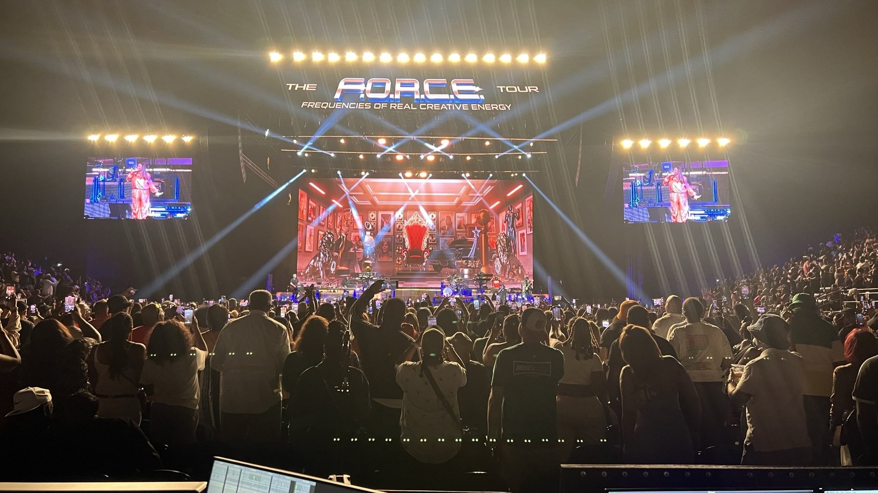 Arena crowd facing a stage with the F.O.R.C.E. Tour sign, a throne set on the video wall and light beams